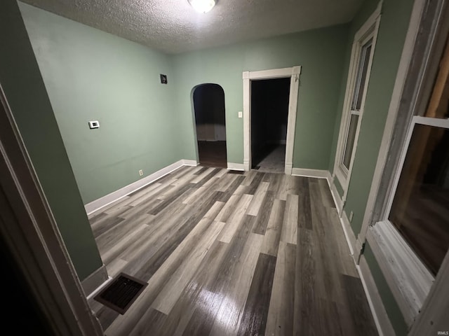 empty room featuring hardwood / wood-style floors and a textured ceiling