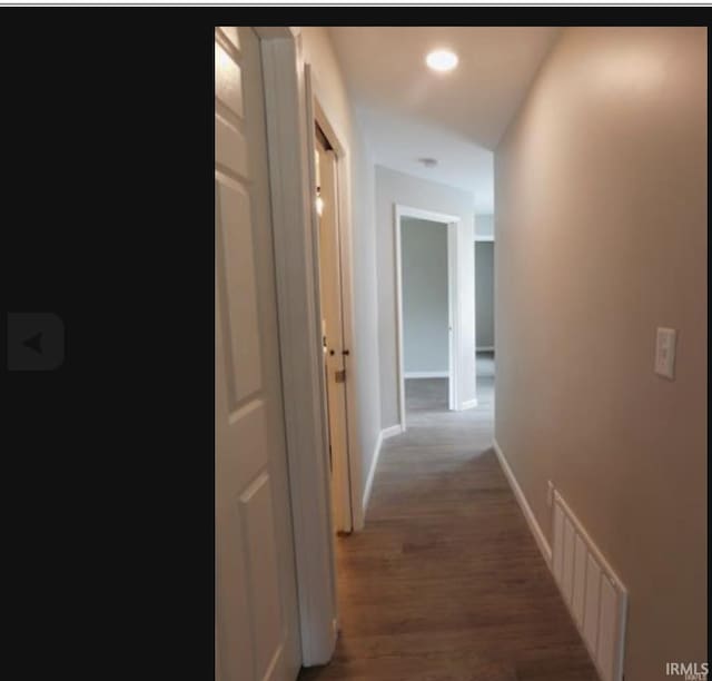 corridor featuring dark hardwood / wood-style floors