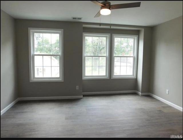 spare room with ceiling fan and hardwood / wood-style floors