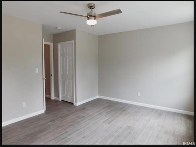 unfurnished room featuring ceiling fan and hardwood / wood-style flooring