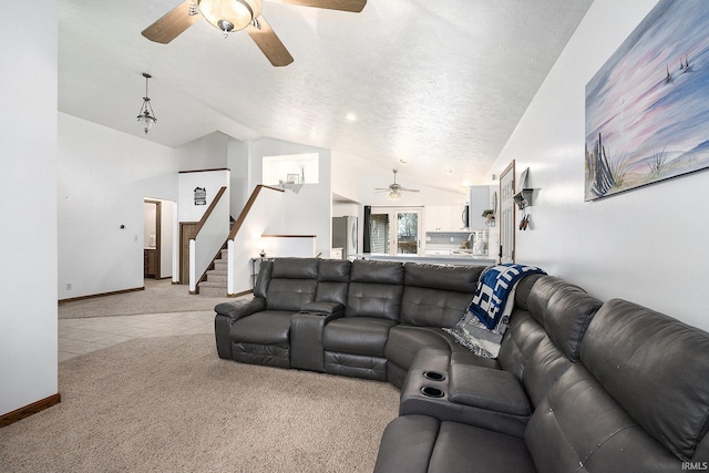 carpeted living room with ceiling fan, lofted ceiling, and a textured ceiling