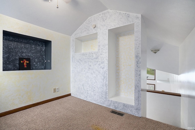 empty room with carpet, ceiling fan, and lofted ceiling