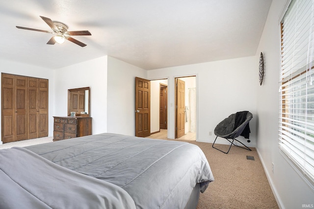 carpeted bedroom featuring ceiling fan and a closet