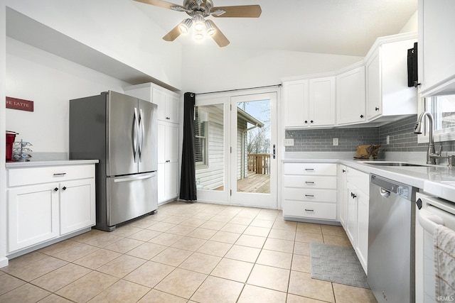 kitchen featuring white cabinets, stainless steel appliances, and a wealth of natural light