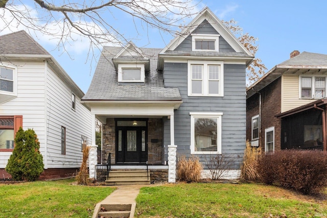 view of front facade with covered porch and a front lawn