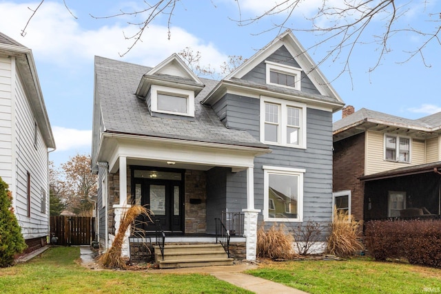 view of front of home with a porch and a front lawn