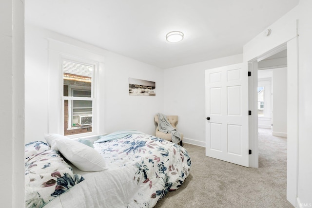 carpeted bedroom featuring multiple windows