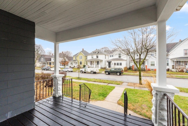 deck with a lawn and covered porch