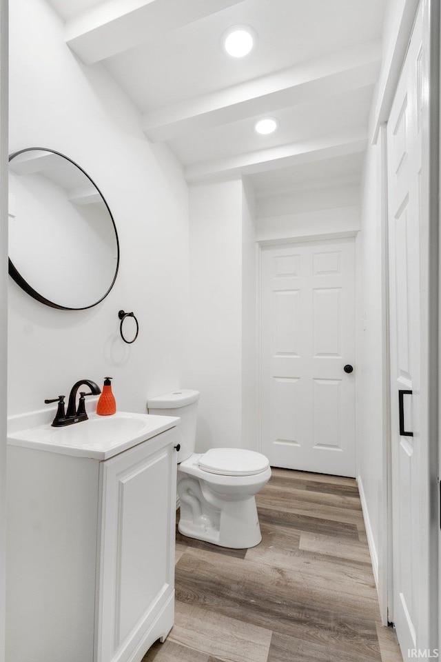 bathroom featuring hardwood / wood-style floors, vanity, and toilet