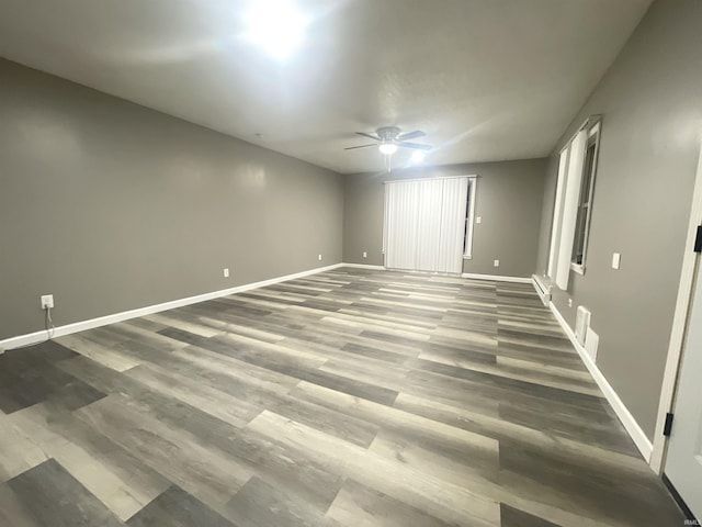 empty room featuring dark hardwood / wood-style floors and ceiling fan