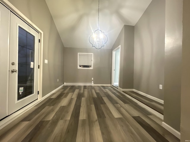 unfurnished dining area featuring vaulted ceiling, dark hardwood / wood-style flooring, baseboard heating, and a chandelier