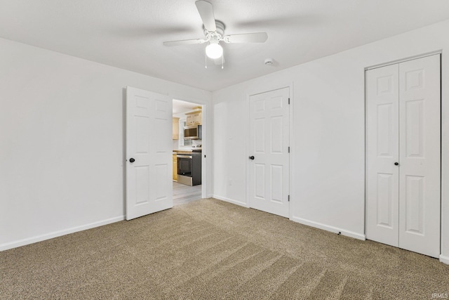 unfurnished bedroom featuring carpet flooring and ceiling fan