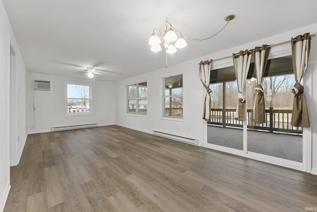 interior space with plenty of natural light, wood-type flooring, and baseboard heating