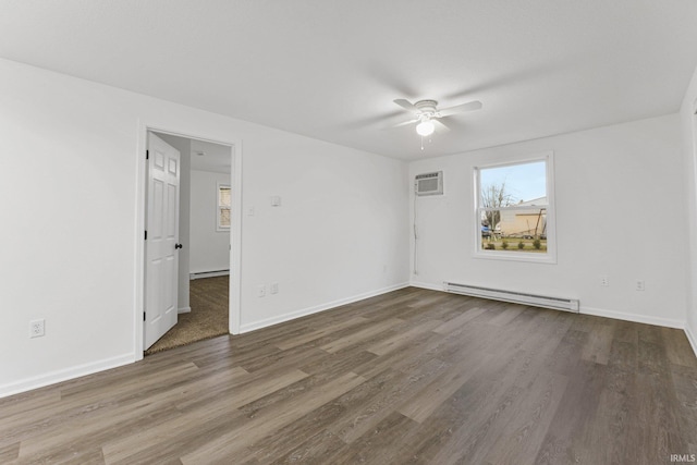 spare room with a wall unit AC, ceiling fan, dark wood-type flooring, and a baseboard heating unit