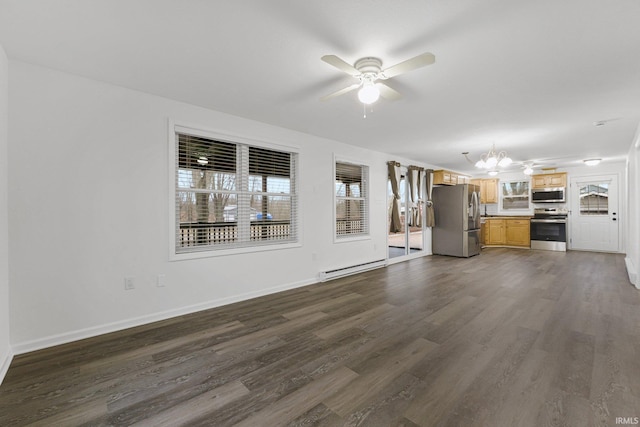 unfurnished living room with ceiling fan with notable chandelier and dark hardwood / wood-style floors