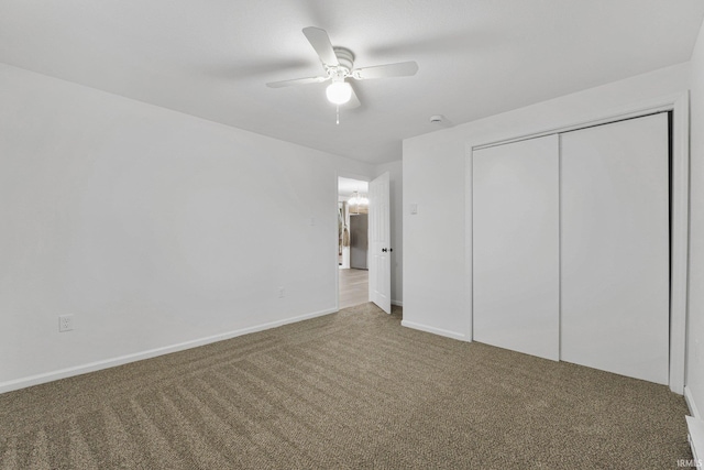 unfurnished bedroom featuring carpet floors, a closet, and ceiling fan