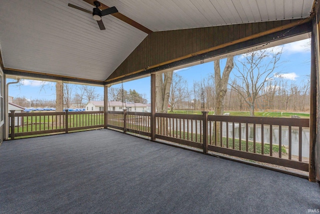 unfurnished sunroom featuring a healthy amount of sunlight, ceiling fan, and lofted ceiling