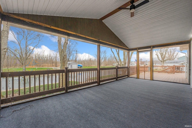 unfurnished sunroom with vaulted ceiling with beams and ceiling fan