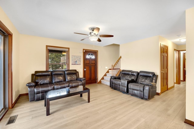 living room with ceiling fan and light hardwood / wood-style flooring