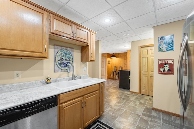 kitchen with dishwasher, a drop ceiling, and sink