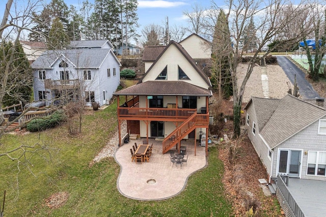 back of property with a patio area, a yard, and a deck