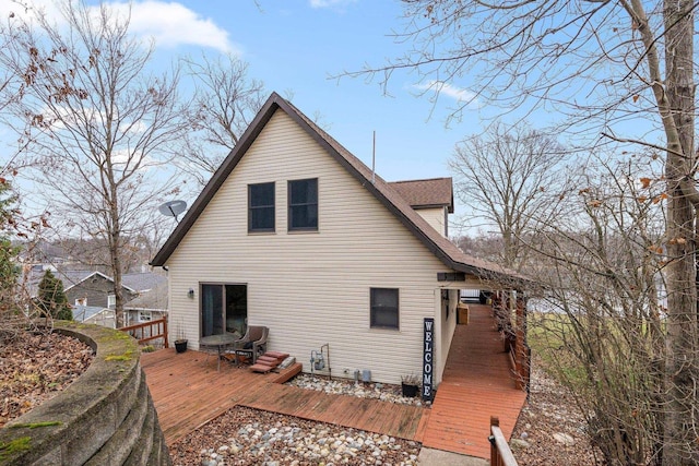 rear view of property featuring a deck