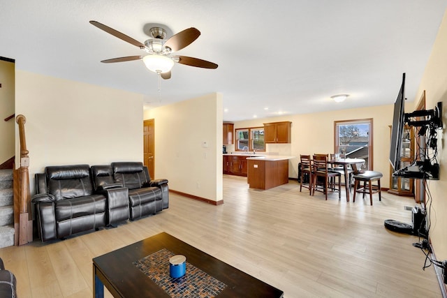 living room featuring ceiling fan and light wood-type flooring