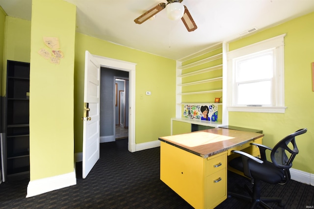 office space featuring ceiling fan and dark carpet