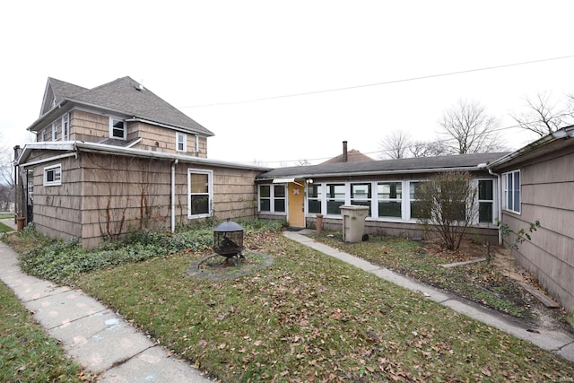 rear view of property with a lawn