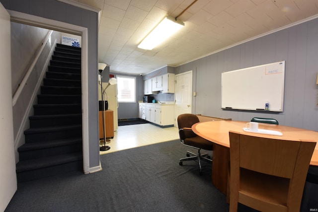 carpeted office space featuring ornamental molding