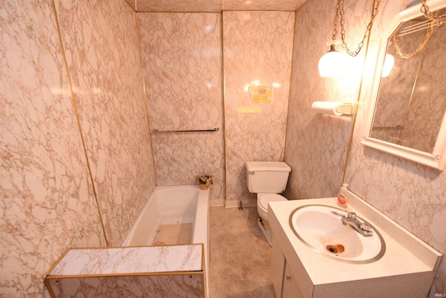 bathroom featuring vanity, toilet, and a bathing tub