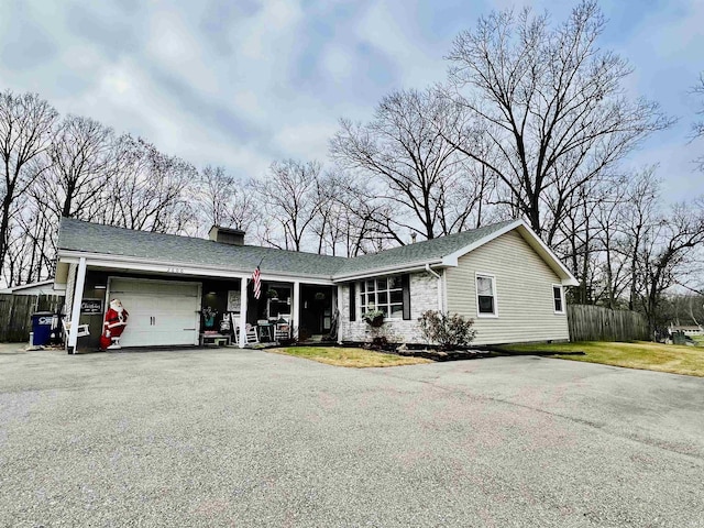 ranch-style house with a porch and a garage