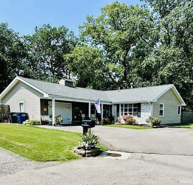 ranch-style home with a front lawn and a garage