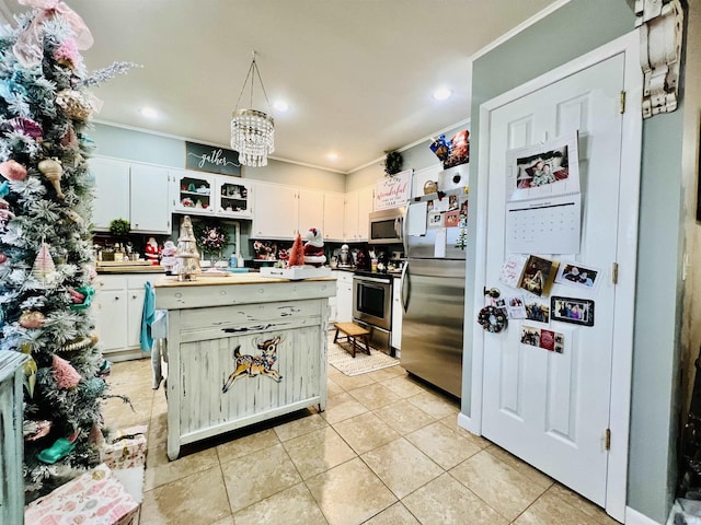 kitchen featuring white cabinetry, light tile patterned floors, pendant lighting, and appliances with stainless steel finishes