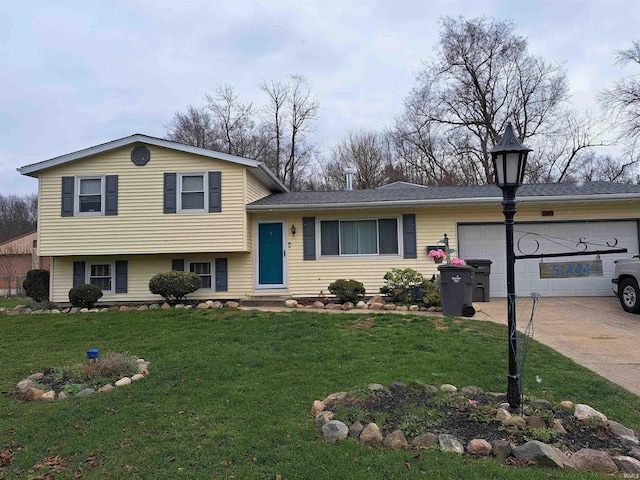 tri-level home with a garage and a front lawn