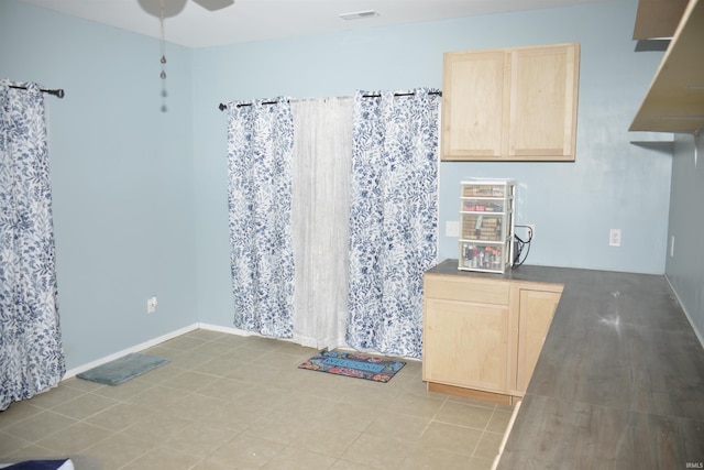 kitchen with light brown cabinetry and ceiling fan