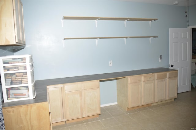 kitchen with light brown cabinets and light tile patterned floors