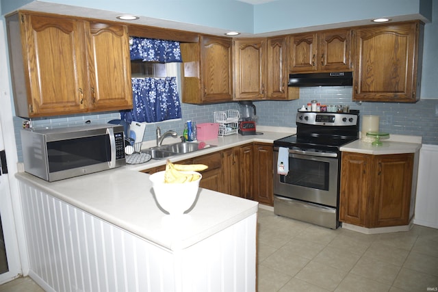 kitchen featuring backsplash, stainless steel appliances, sink, range hood, and light tile patterned flooring