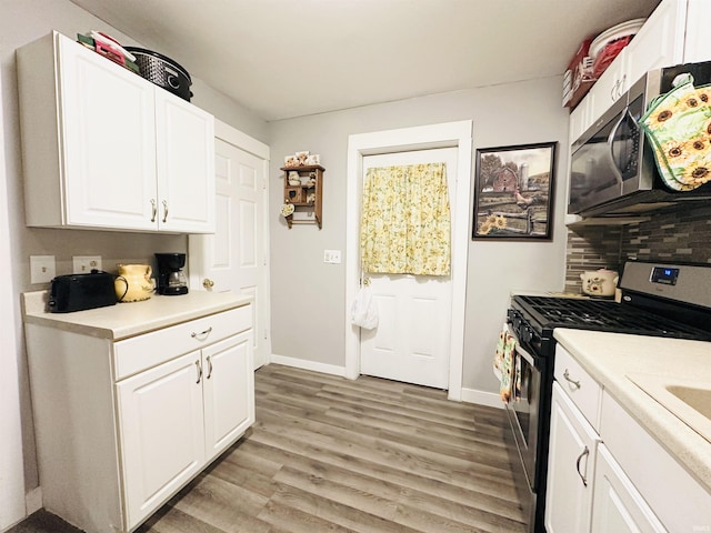 kitchen featuring light hardwood / wood-style floors, white cabinetry, and stainless steel appliances