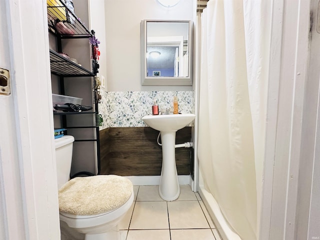 bathroom with toilet and tile patterned floors