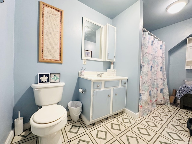 bathroom featuring tile patterned flooring, vanity, and toilet