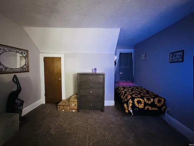 carpeted bedroom featuring lofted ceiling and a textured ceiling