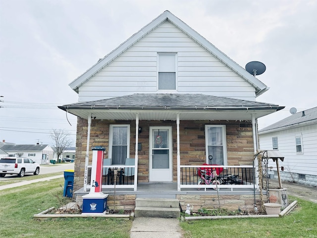 bungalow-style house with covered porch and a front lawn