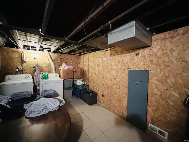 basement featuring washing machine and clothes dryer