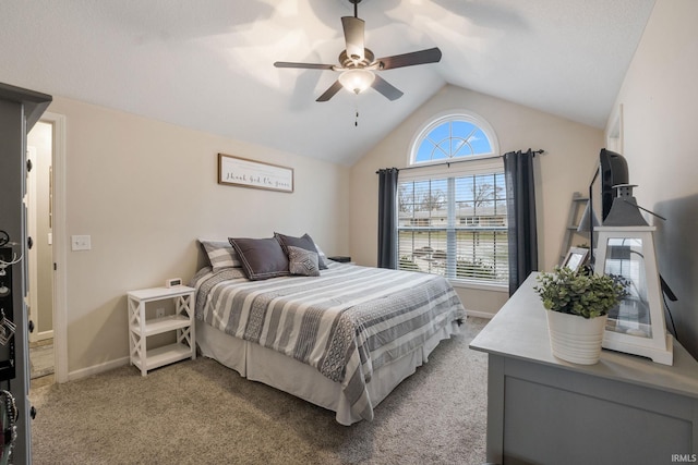 carpeted bedroom with vaulted ceiling and ceiling fan