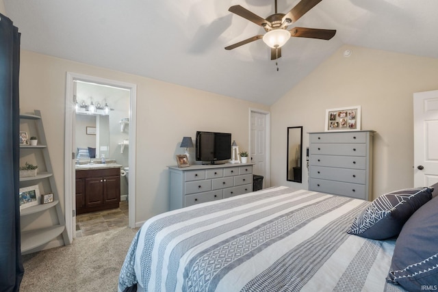 bedroom featuring ensuite bathroom, ceiling fan, light colored carpet, and lofted ceiling