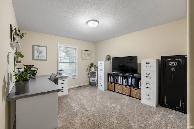 home office with a textured ceiling and light carpet