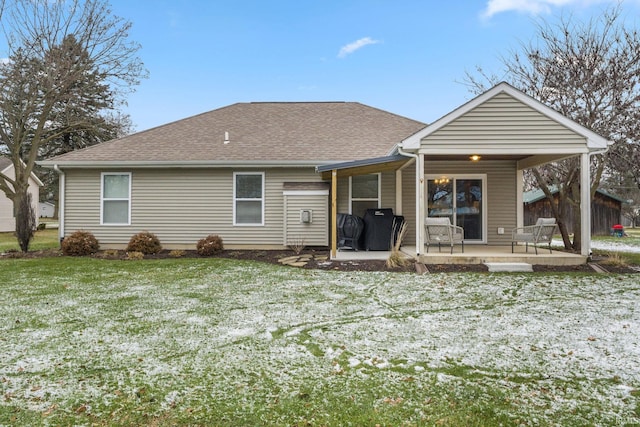 rear view of property featuring a lawn and a patio