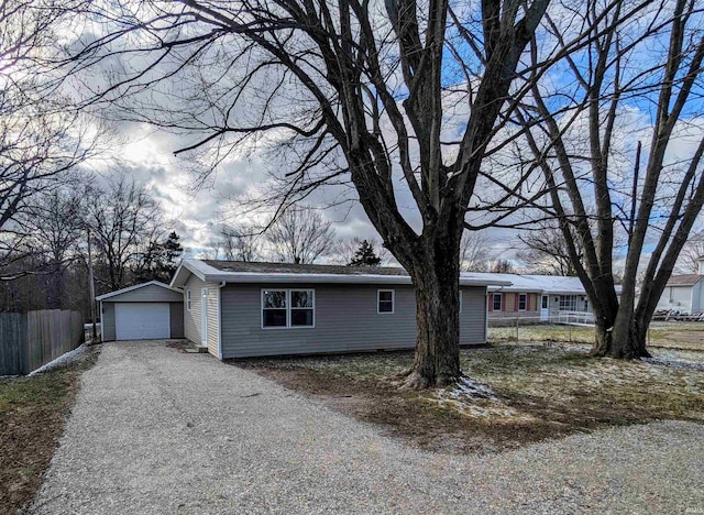 single story home with a garage and an outbuilding