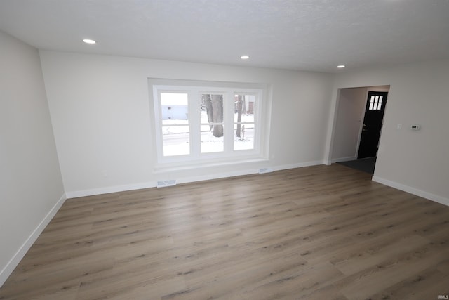 unfurnished room with hardwood / wood-style flooring